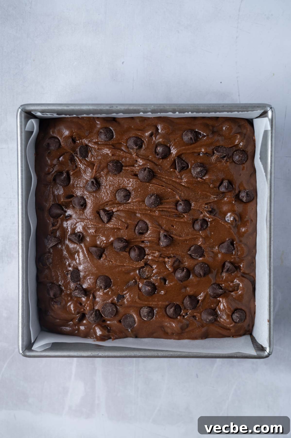One-Bowl Double Chocolate Chip Bars 9 double chocolate cookie bars dough in a parchment lined baking pan
