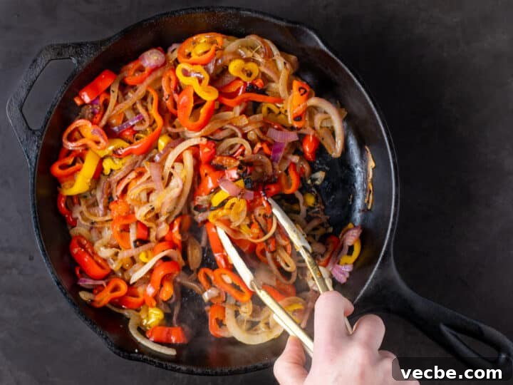 Caramelized Chipotle Chicken Fajitas Recipe 12 sautéed peppers and onions in a cast iron skillet
