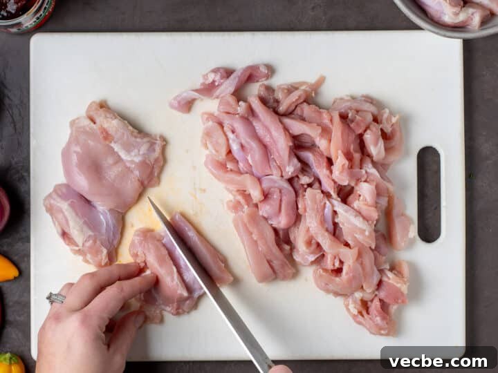 Caramelized Chipotle Chicken Fajitas Recipe 6 hands using a knife to slice chicken thighs