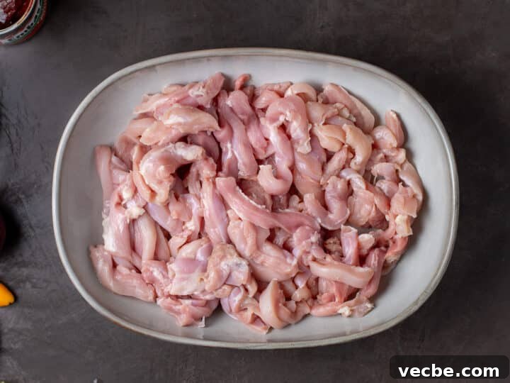 Caramelized Chipotle Chicken Fajitas Recipe 7 sliced chicken thighs in a shallow bowl