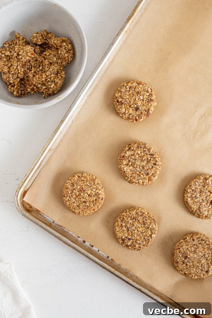Vegan Tahini Date Cookies Recipe 5 Bowl of cookie dough beside a baking tray of cookies.