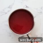 No Bake Strawberry Jello Pie Recipe 9 strawberry jello filling in a saucepan.