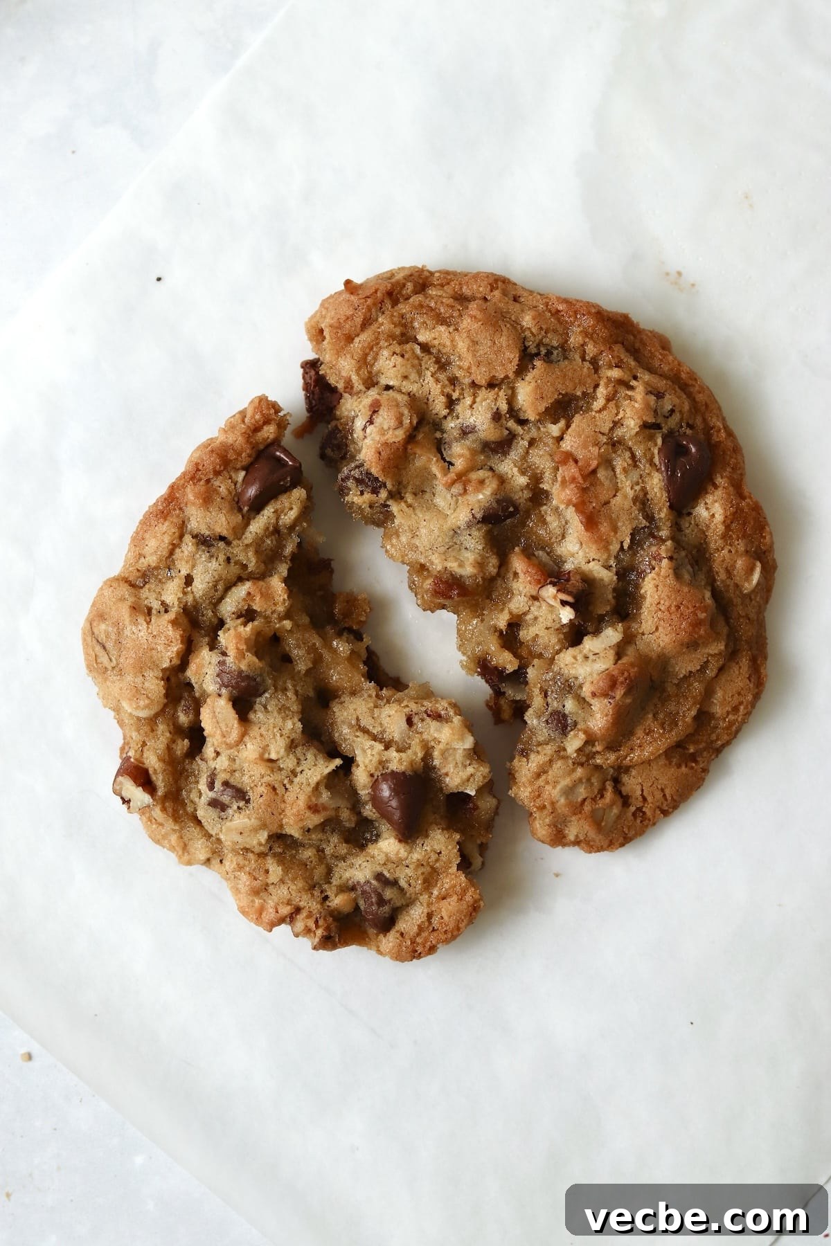 Single-Serve Cowboy Cookie Recipe for One - Small Batch 2 Single serve cowboy cookie with oats and pecans broken in half.