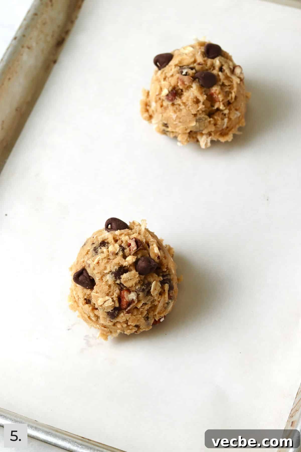 Single-Serve Cowboy Cookie Recipe for One - Small Batch 8 Cowboy cookie dough ball on a baking sheet.