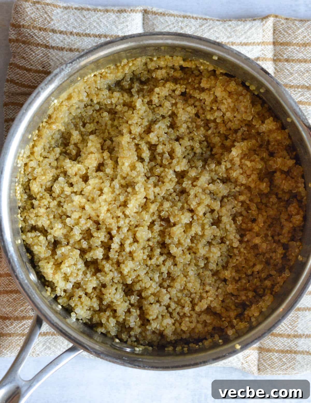 Herbed Quinoa Salad with Avocado and Chickpeas 5 a saucepan with cooked quinoa in it.