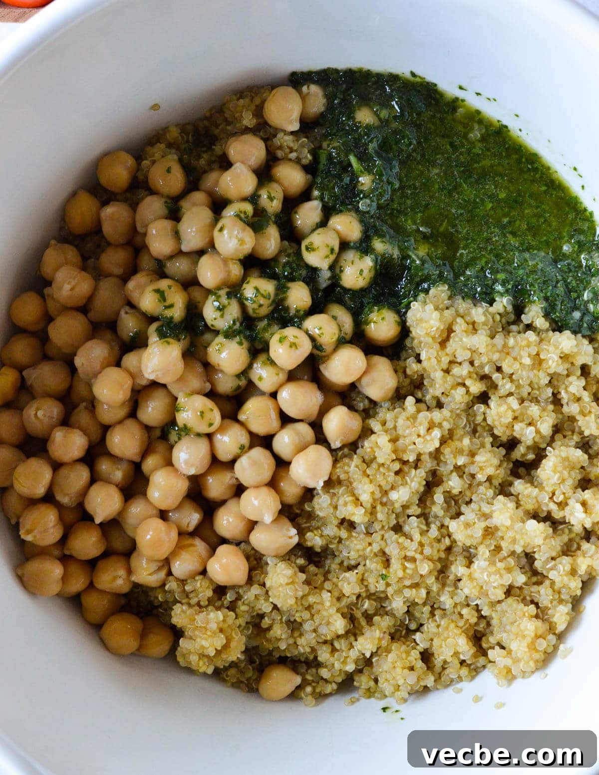 Herbed Quinoa Salad with Avocado and Chickpeas 8 herb vinaigrette, chickpeas, and cooked quinoa in a bowl.