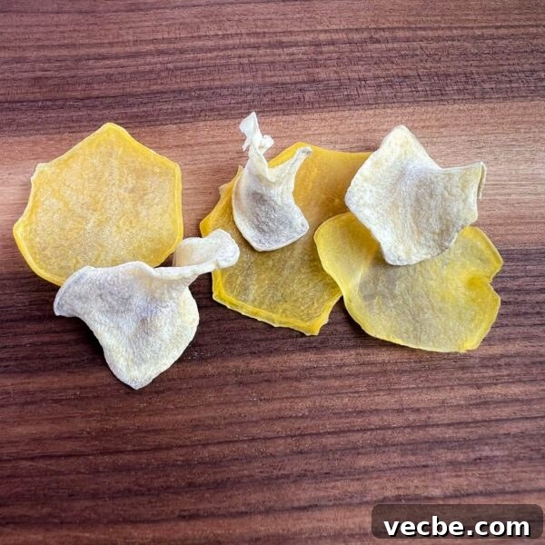 Dehydrate Potatoes: Oven and Dehydrator Methods for Storage 8 slices of dried blanched and not blanched potatoes on cutting board