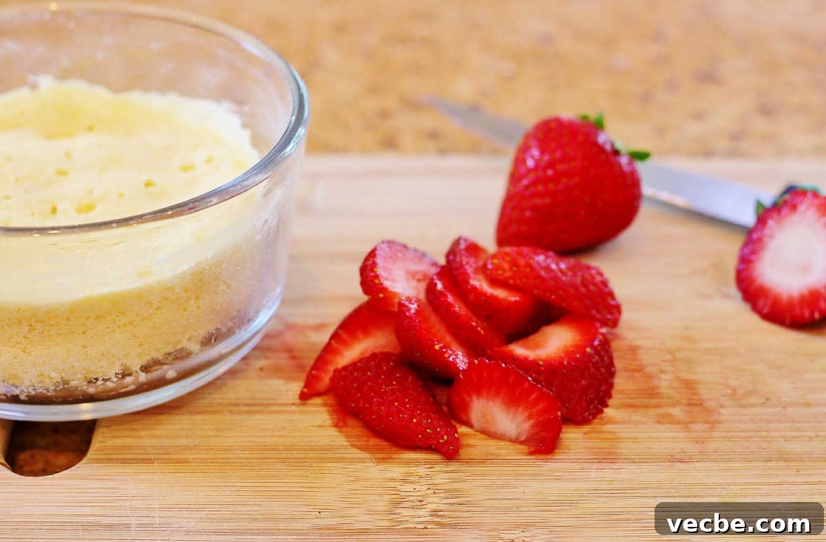 Quick Paleo Strawberry Lemon Shortcake Recipe 3 Chopping the berries and cooking the shortcake.