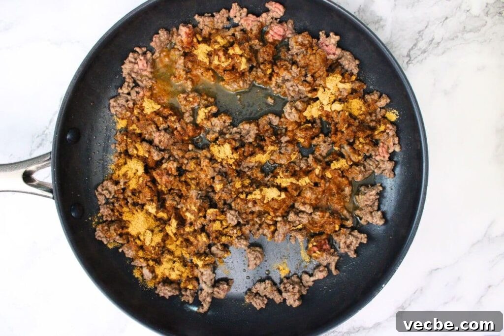 Crispy Air Fryer Ground Beef Nachos for Game Day 6 add taco seasoning to the ground beef