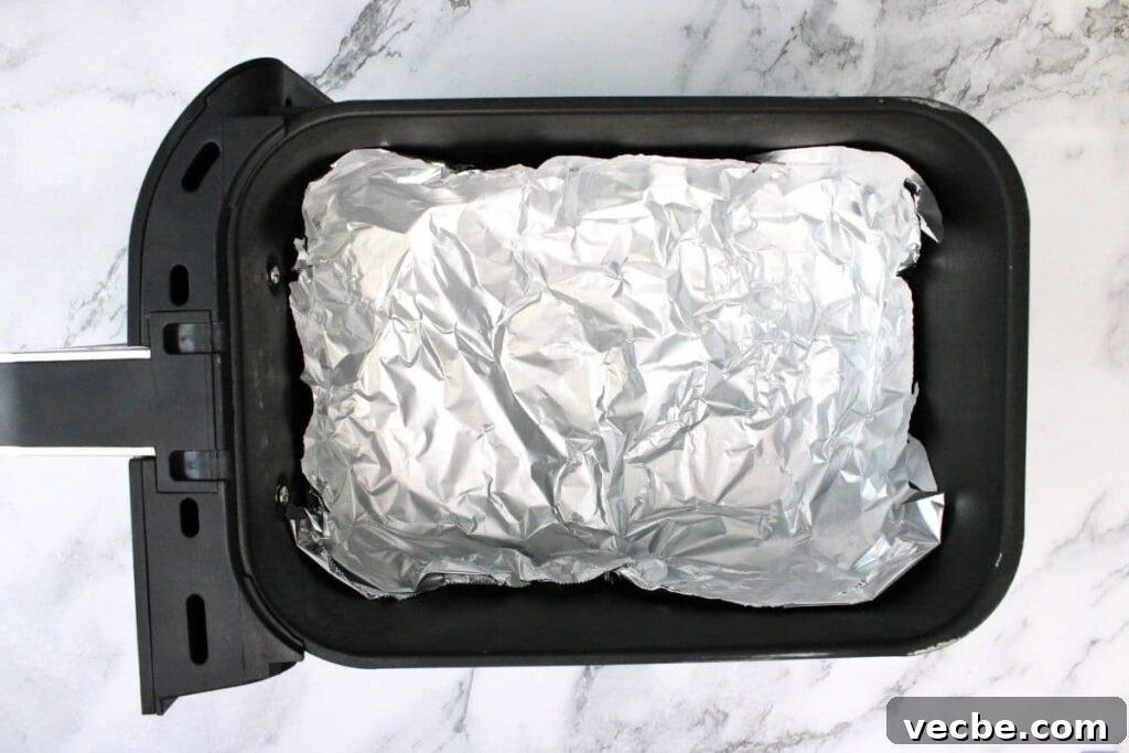 Crispy Air Fryer Ground Beef Nachos for Game Day 7 line air fryer basket with foil to create a bowl