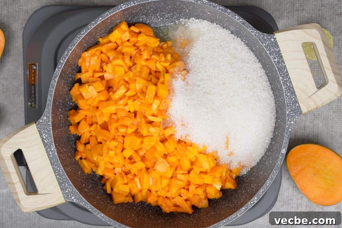Mango Coulis Recipe: Silky Sweet Sauce for Desserts 4 Mangoes, sugar and lemon juice added to a pan.