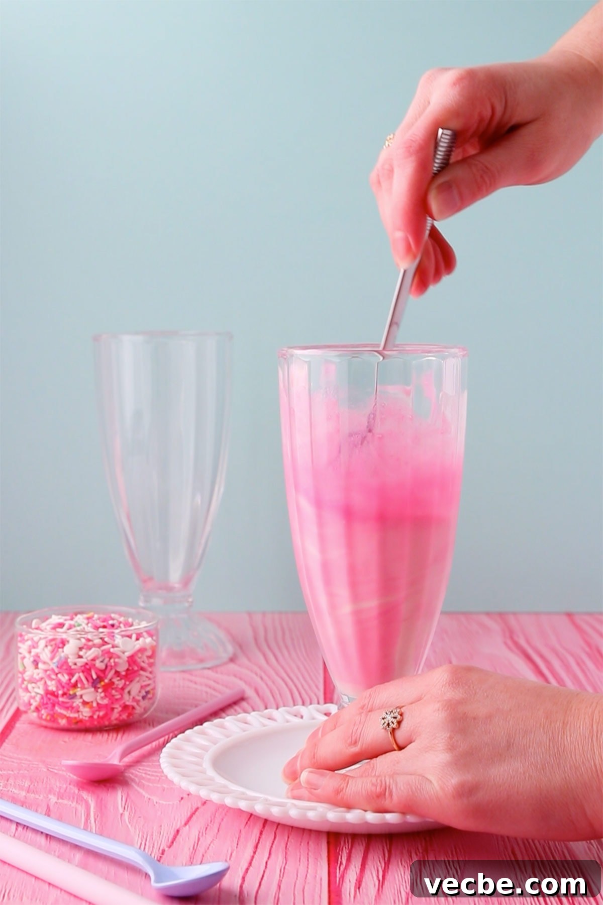 Pink Panther Raspberry Lemonade Ice Cream Float Recipe 4 A tall glass with ice cream and cordial being mixed together.