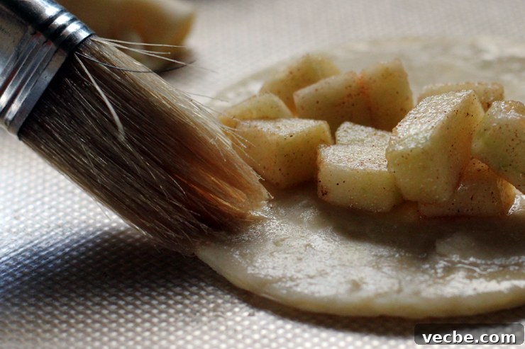 AppleCheddarHandpiesAppleFill Brushing dough edges with water.