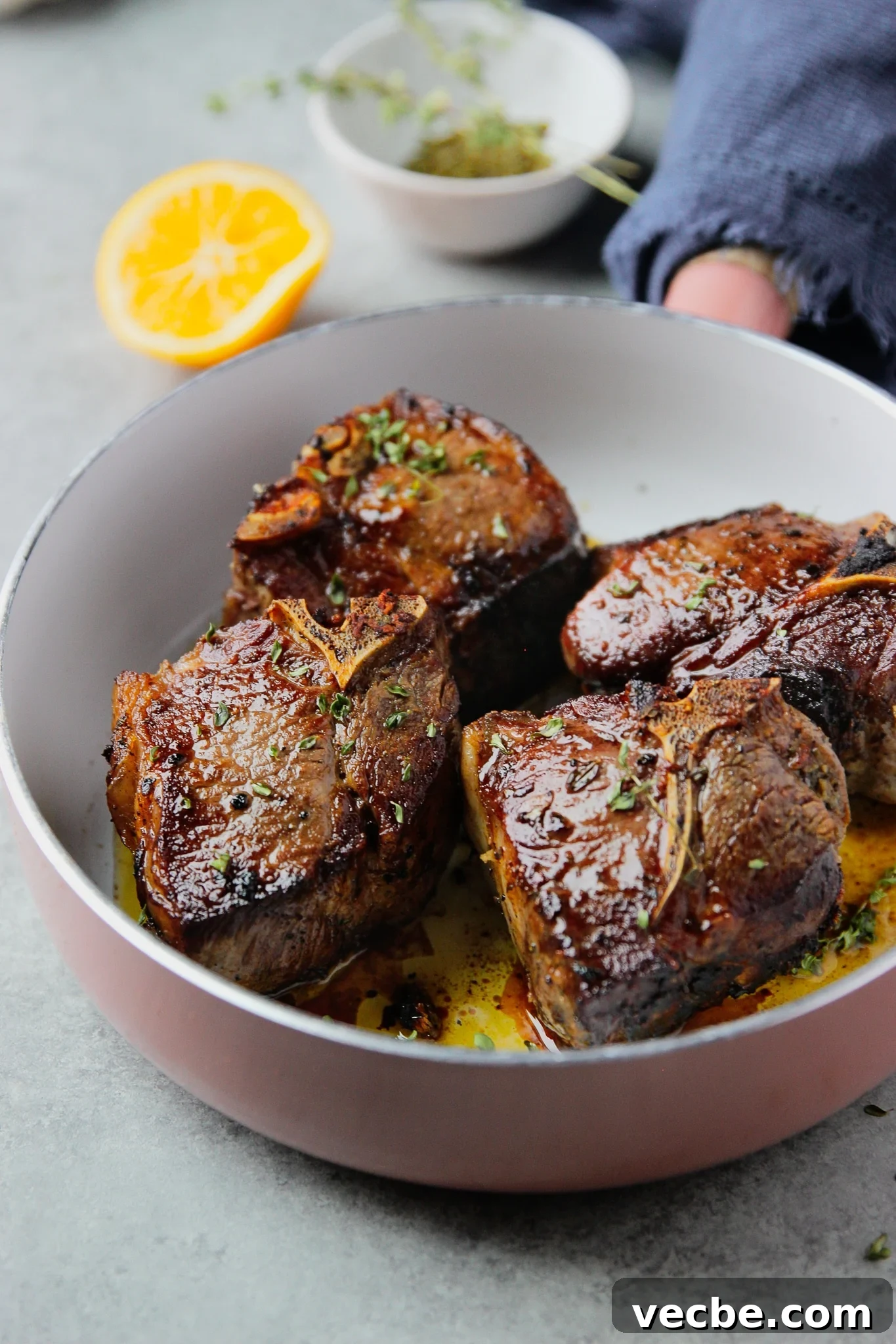 Pan-Seared Garlic & Herb Lamb Loin Chops 8 4 cooked lamb loin chops in a large skillet.