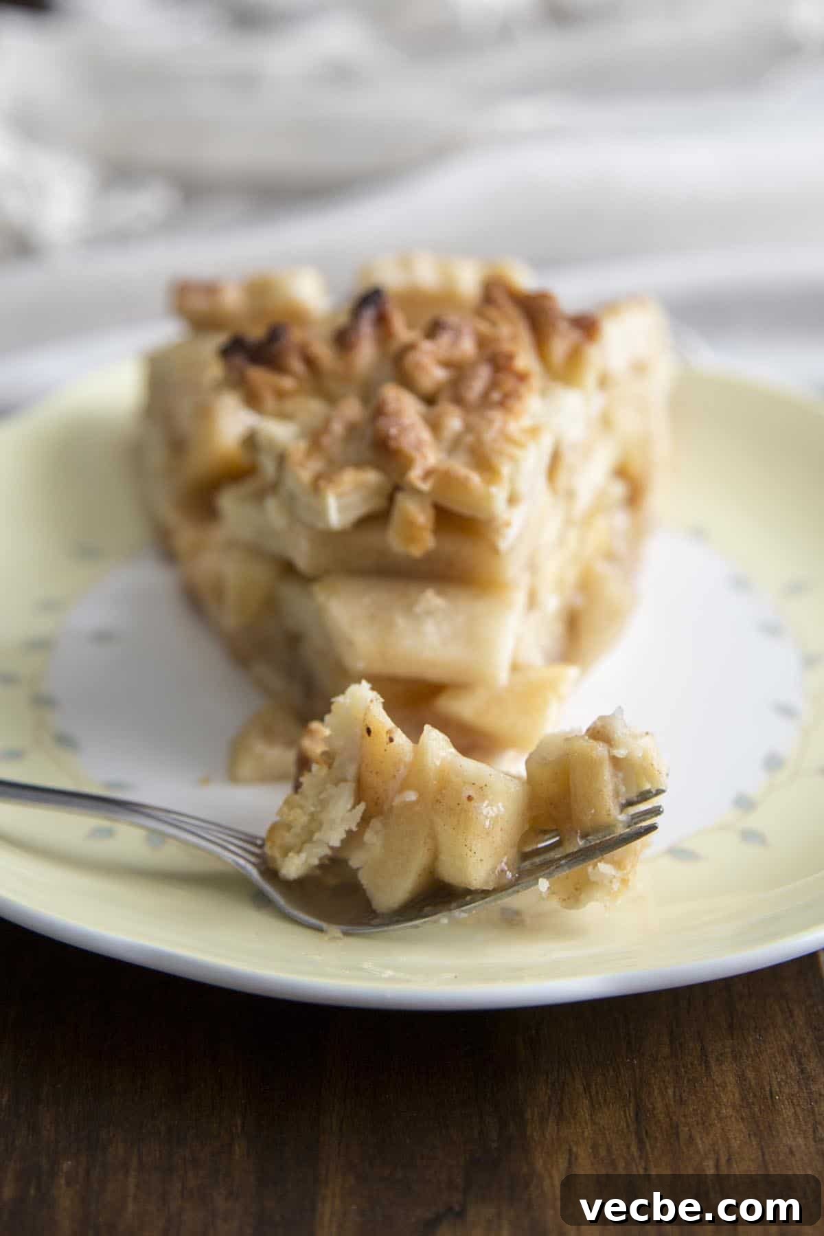 Apple Pie with a Maple Leaf Crust 11 A slice of apple pie on a plate.