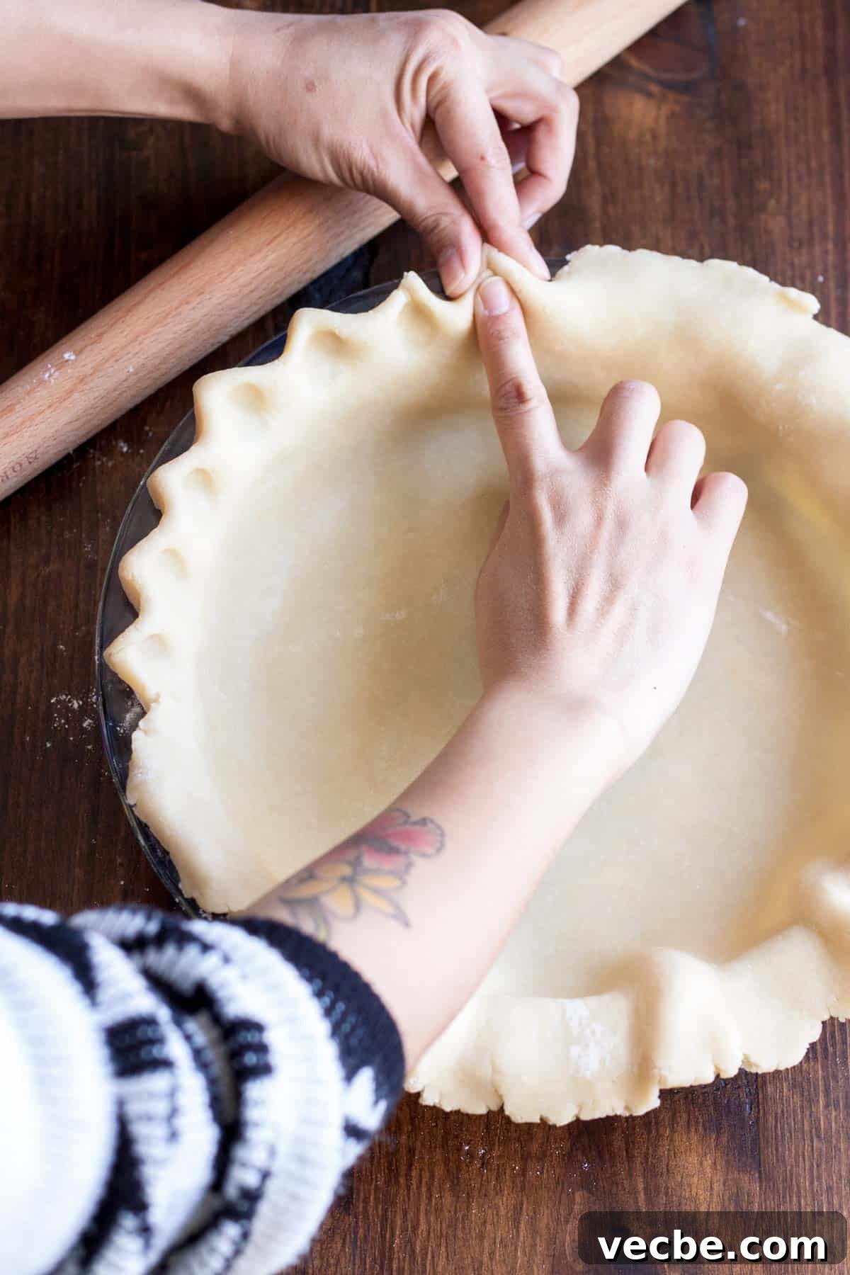 Apple Pie with a Maple Leaf Crust 5 Fluting the edge of pie crust in a pie pan.