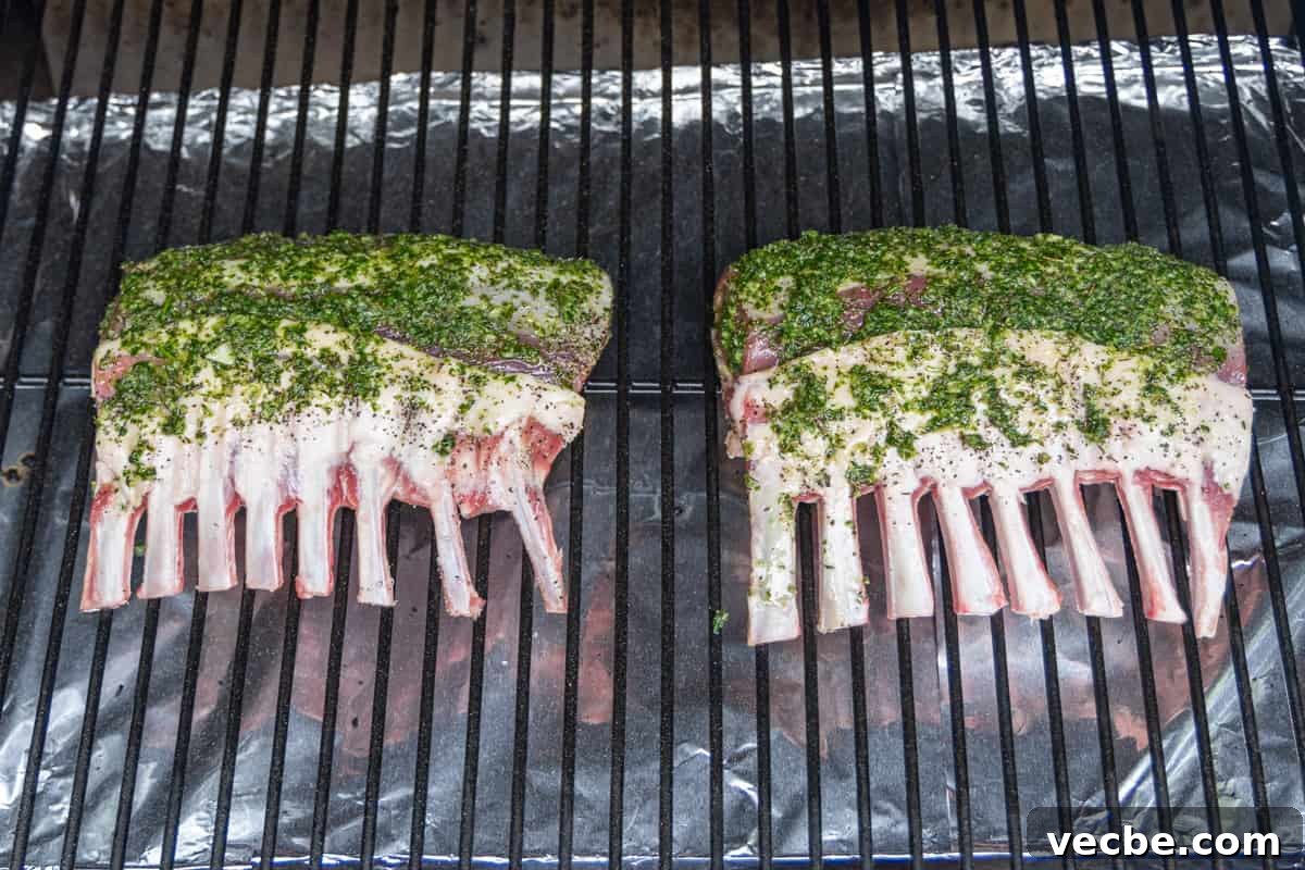 Smoked Lamb Chops Recipe with Garlic and Rosemary 7 Two racks of lamb on smoker covered in marinade.
