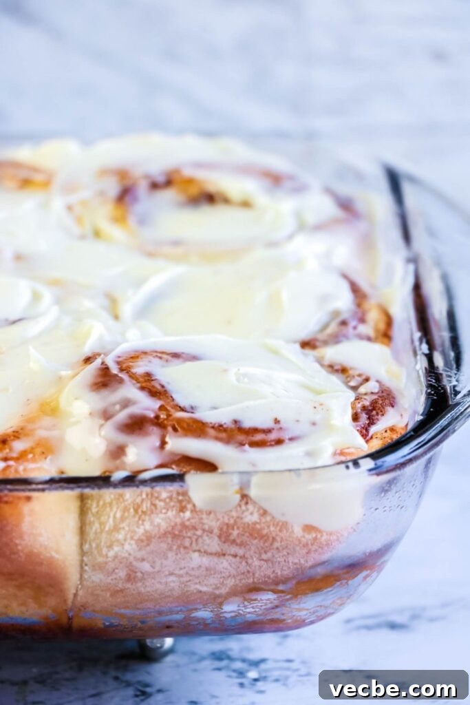 Bread Machine Cinnamon Rolls with Cream Cheese Icing 8 Cinnamon rolls close up in glass dish