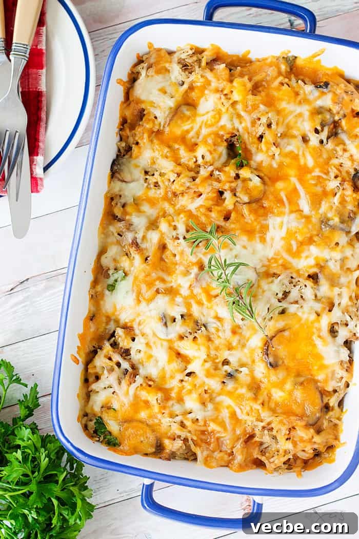 Cheesy Leftover Turkey Casserole Recipe 4 A flat lay of the white dish with casserole with melted cheese on top