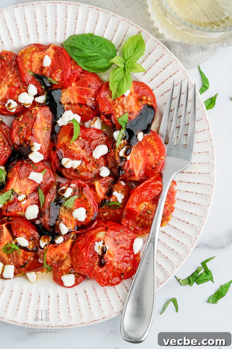 Air Fryer Roasted Tomatoes Recipe 2 a plate with roasted tomatoes, cheese, basil and balsamic.