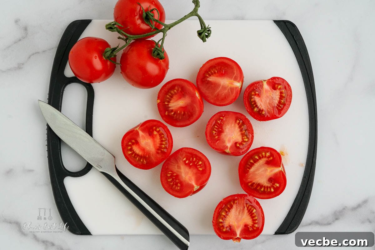 Air Fryer Roasted Tomatoes Recipe 4 slicing tomatoes on a chopping board