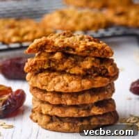 Chewy Date Oatmeal Cookies with Cinnamon 9 A stack of oatmeal date cookies with the one on top broken in half to show the inside.