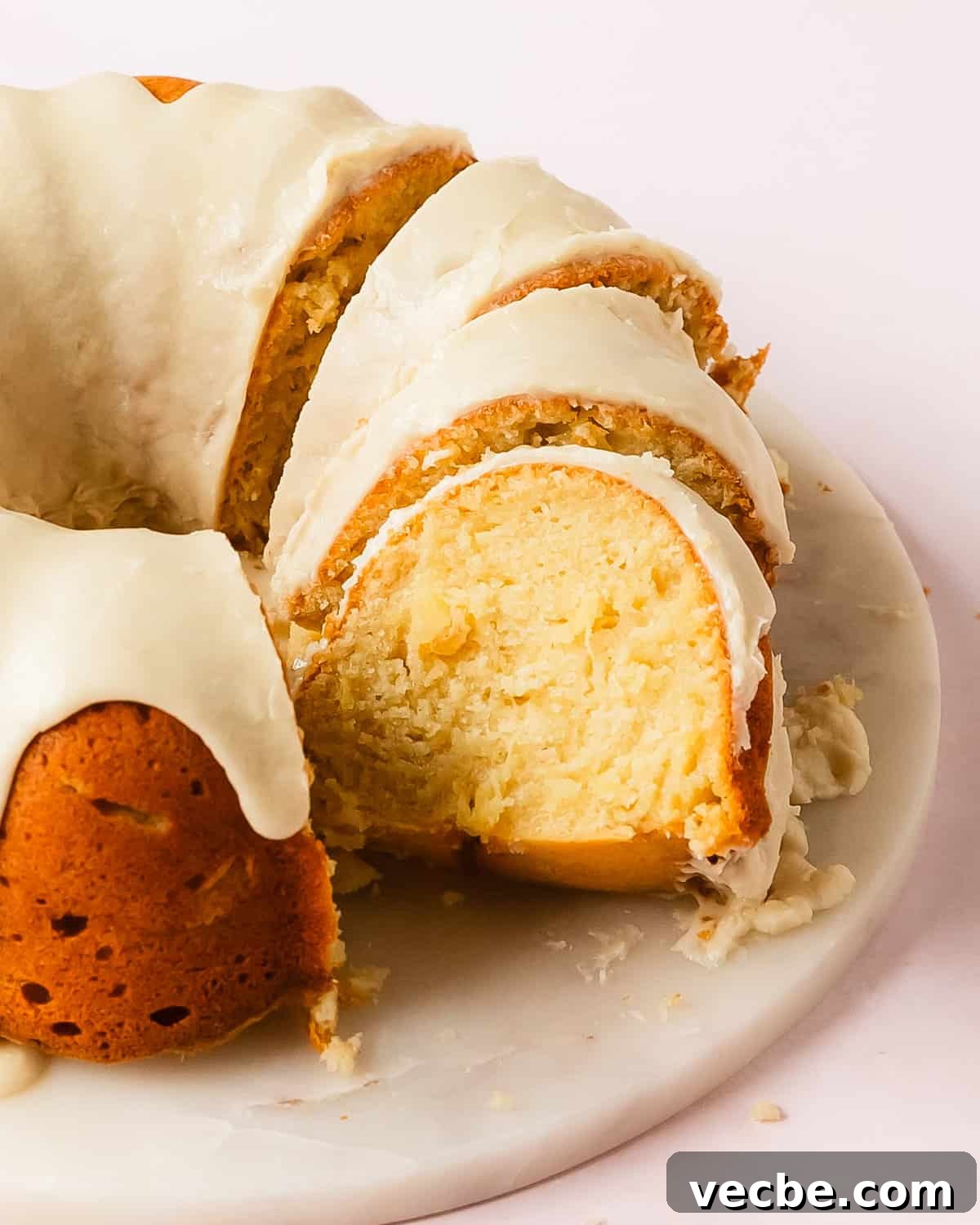 Moist Pineapple Pound Cake with Sweet Tropical Flavor 8 Slice of moist pineapple pound cake with glaze.