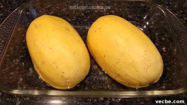 How To Cook Spaghetti Squash Spaghetti squash halves placed cut side down in a baking dish with water