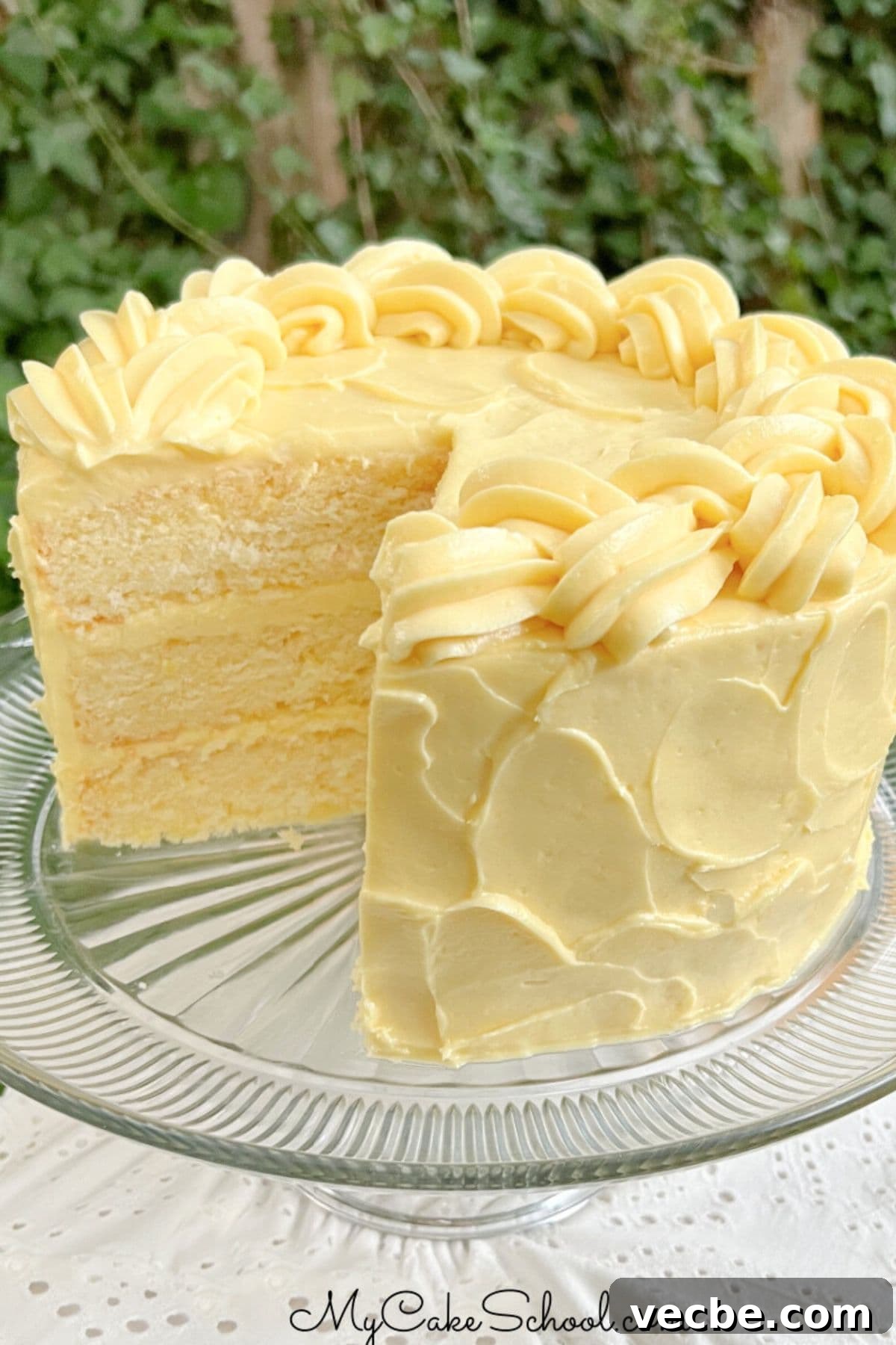 Lemonade Layer Cake Recipe with Bright Lemon Frosting 2 Lemonade Layer Cake, sliced, on a cake pedestal.