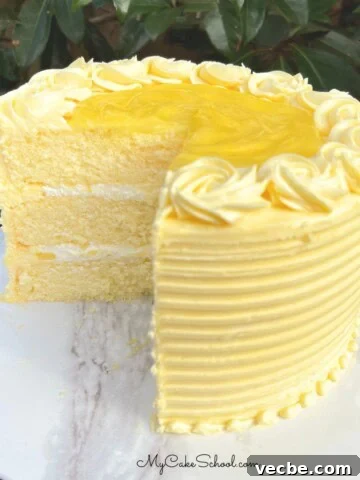 Lemon Velvet Cake, sliced, on a cake pedestal.