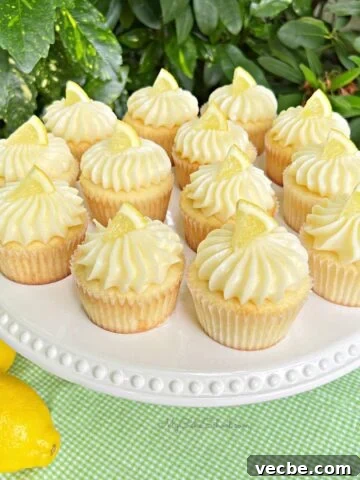 Lemon Cupcakes with Lemon Cream Cheese Frosting on white pedestal