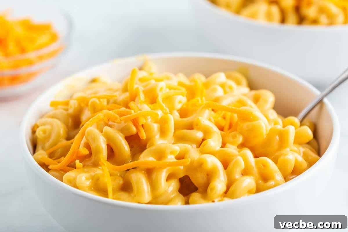 Creamy Instant Pot Mac and Cheese 3 Bowl of and cheese with cheese on top
