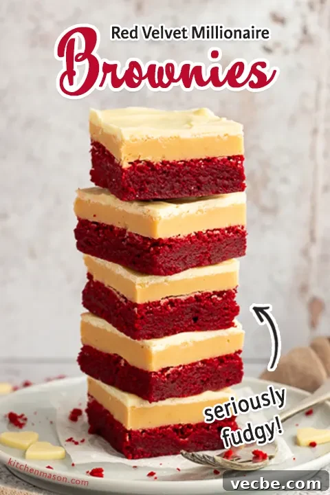 Red Velvet Millionaire Brownies Recipe with Caramel and Chocolate 16 A stack of 5 red velvet millionaire brownies set on two stacked plates with a fork on the side.