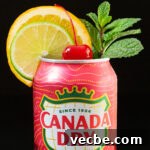 How to Make Canned Christmas Punch 4 A can of cranberry flavored ginger ale has had the top removed and is garnished with a lime wheel, an orange wheel, a sprig of mint, and a maraschino cherry in the middle.