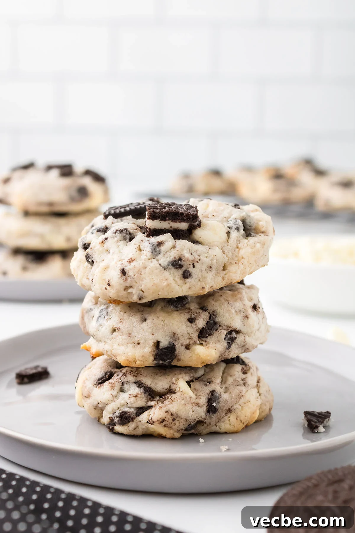 Cookies and Cream Cheesecake Cookie Bites 2 Three Cookies and Cream Cheesecake Cookies stacked on a white plate.