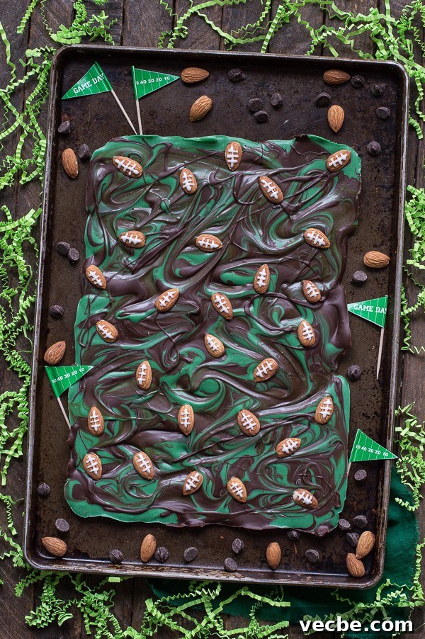 Game Day Football Chocolate Bark 2 Football bark recipe for game day or the Super Bowl, made with chocolate, green candy melts, almonds, and royal icing.