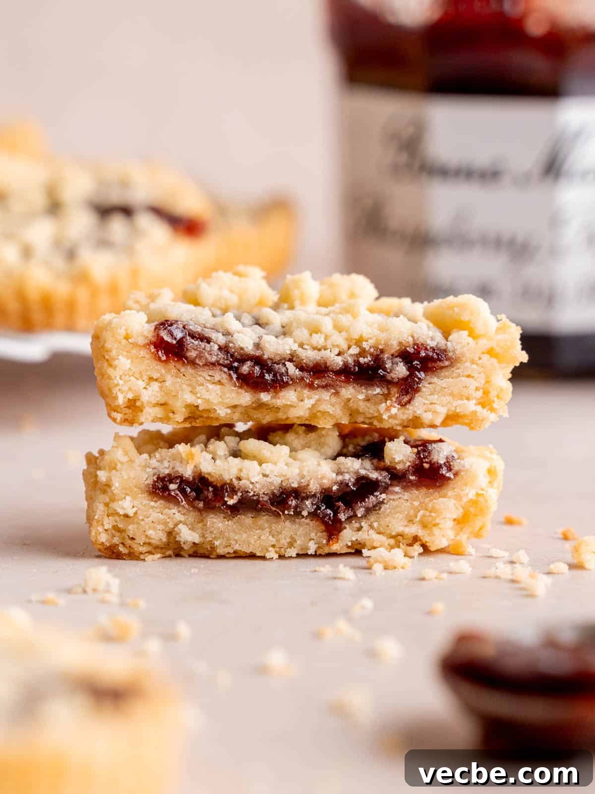 Raspberry Crumble Cookies Better Than Costco 2 Two halves of a raspberry crumble cookie stacked on top of each other.