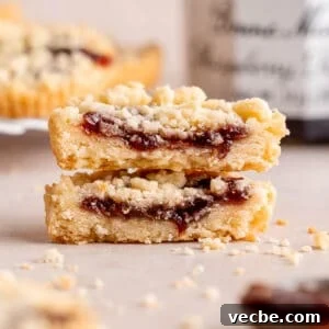 Raspberry Crumble Cookies Better Than Costco 12 Two halves of a raspberry crumble cookie stacked on top of each other.