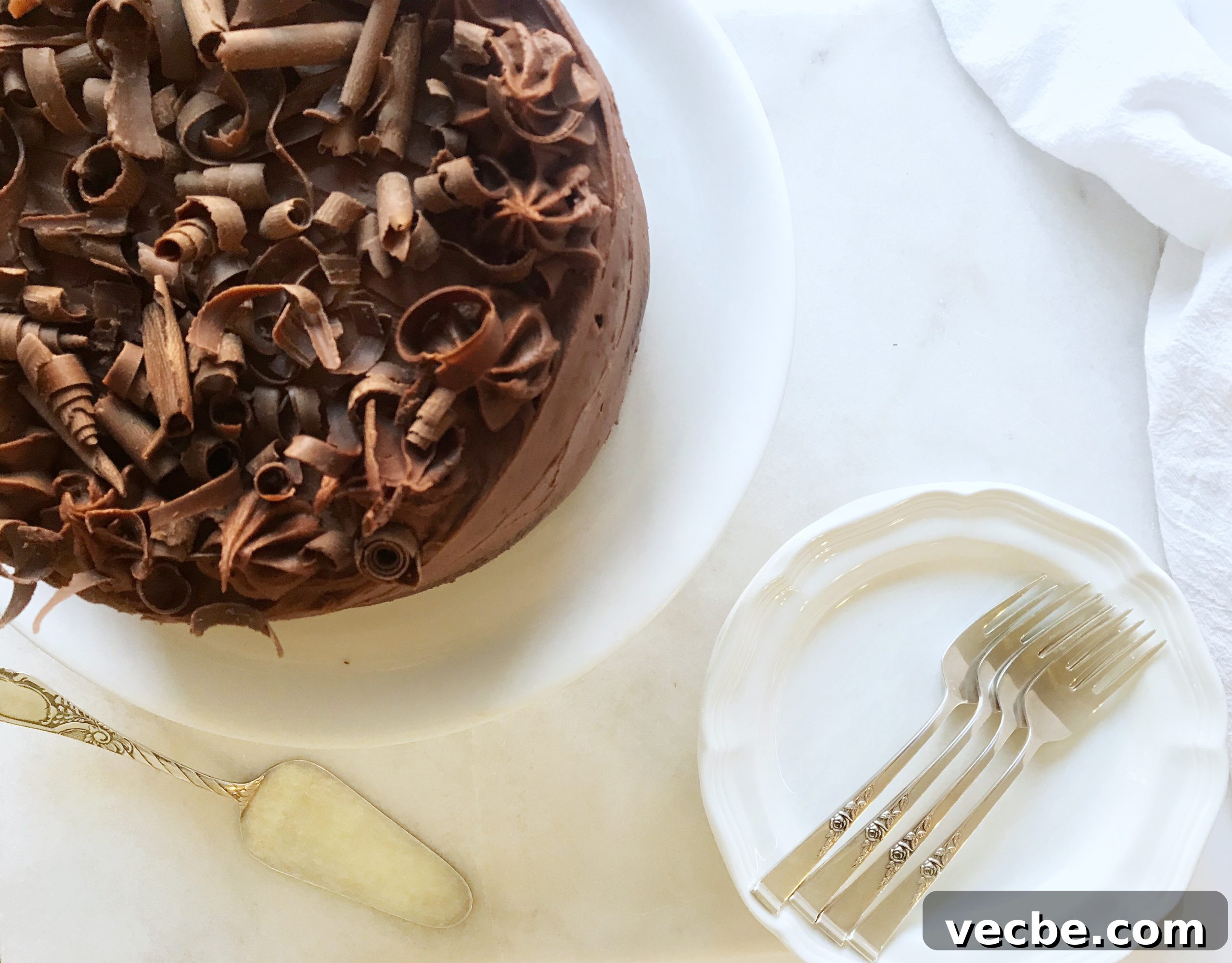 Moist and Decadent Chocolate Cake Recipe 5 ready to serve the perfect chocolate cake with forks and white plates