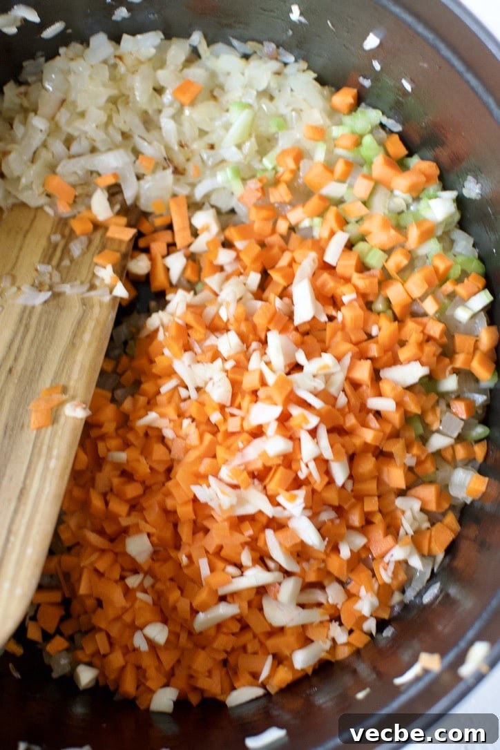Chicken Ragu with Spaghetti Squash Nests Recipe 5 Adding the carrots, celery, and garlic to the pot.