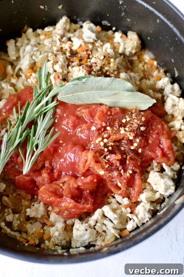 Chicken Ragu with Spaghetti Squash Nests Recipe 7 Tomatoes, herbs and seasonings added to the pot.
