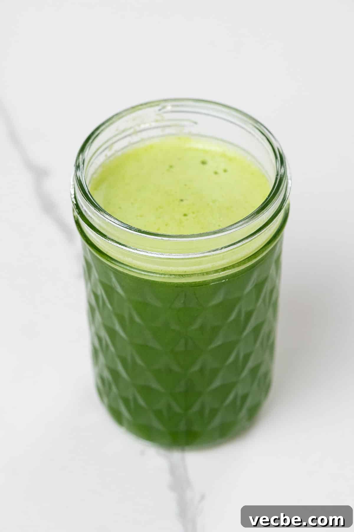 Fresh Spinach Juice Recipe for Energy and Detox 2 spinach juice with pineapple, green apple, and lime in a small glass