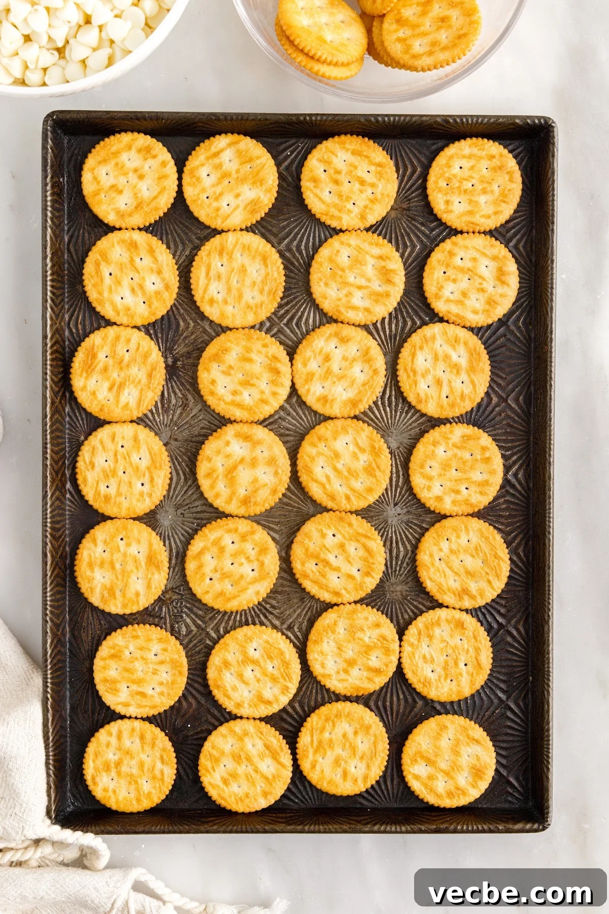 Chocolate-Dipped Peanut Butter Ritz Cracker Bites 5 Ritz crackers laid out flat on a cookie sheet.
