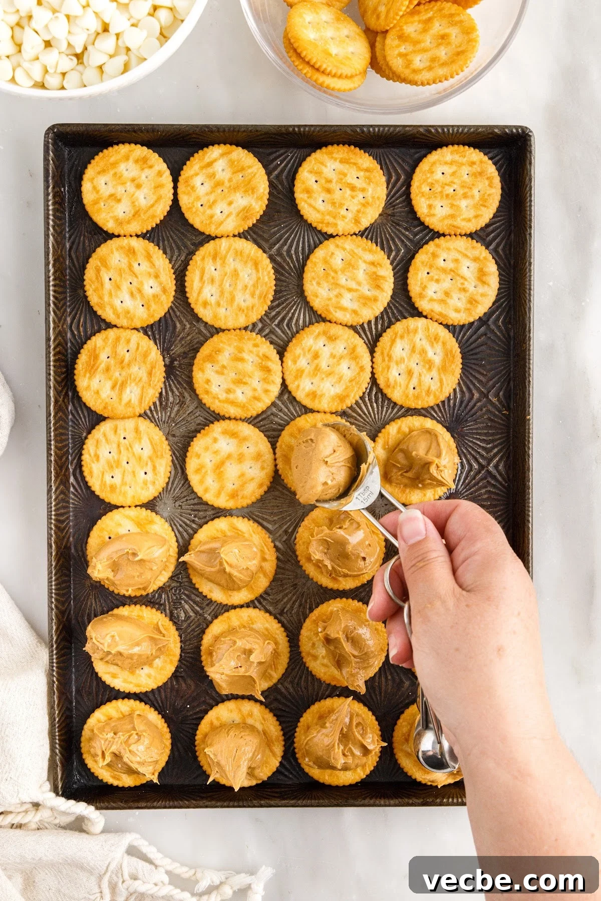 Chocolate-Dipped Peanut Butter Ritz Cracker Bites 6 Spooning the peanut butter mixture on each cracker.