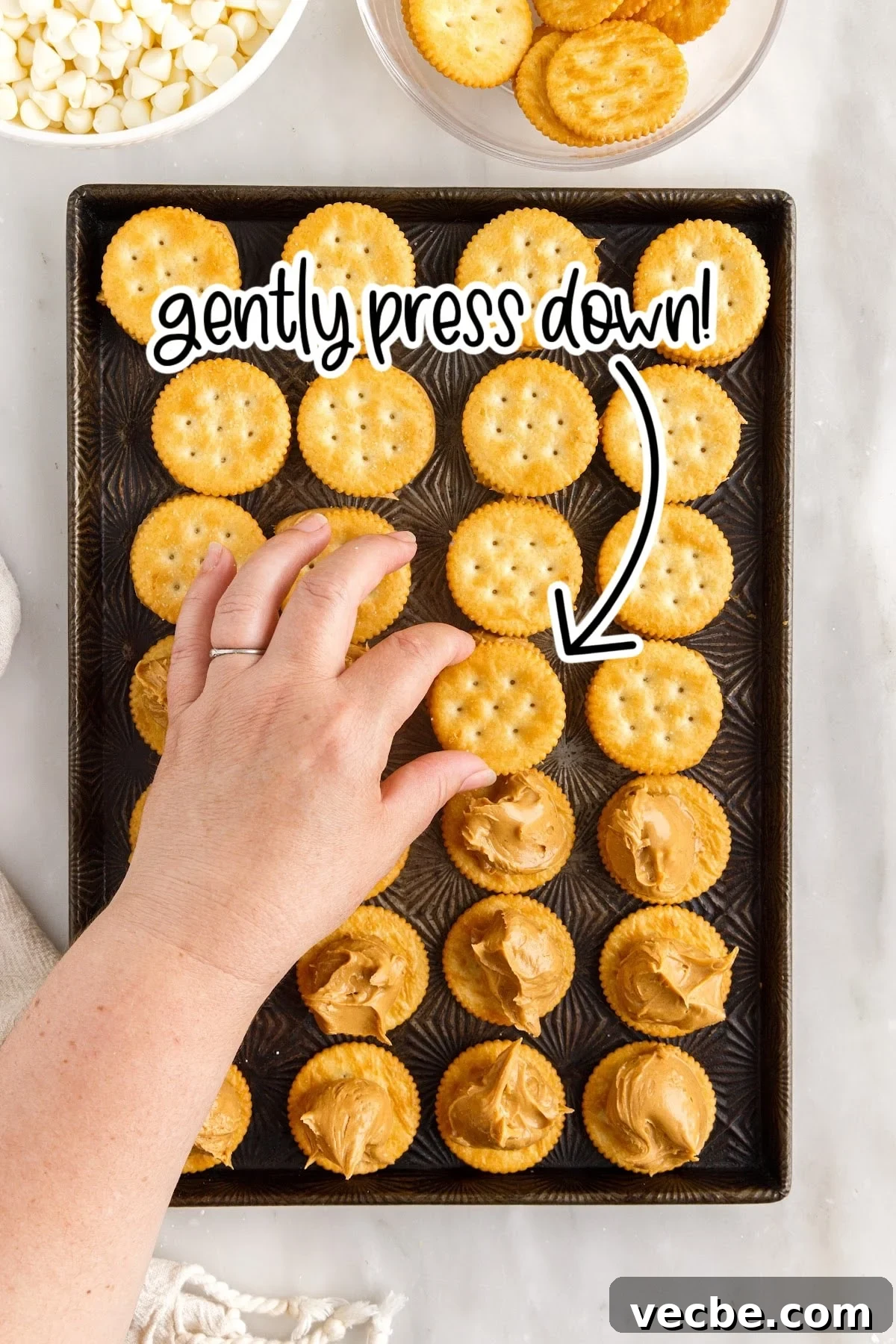 Chocolate-Dipped Peanut Butter Ritz Cracker Bites 7 Placing the top cracker onto the peanut butter.