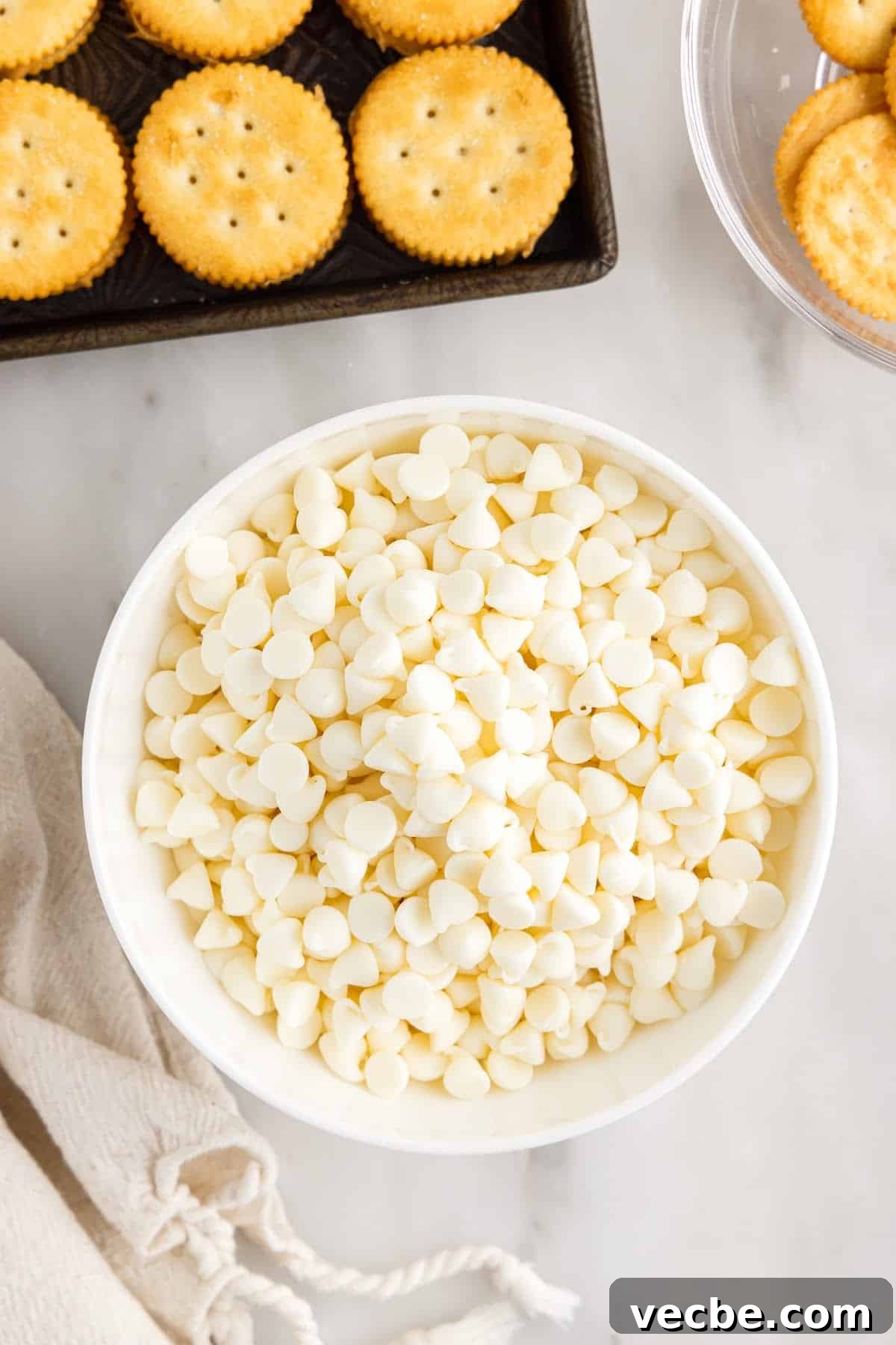 Chocolate-Dipped Peanut Butter Ritz Cracker Bites 8 White chocolate chips in a bowl ready to melt.