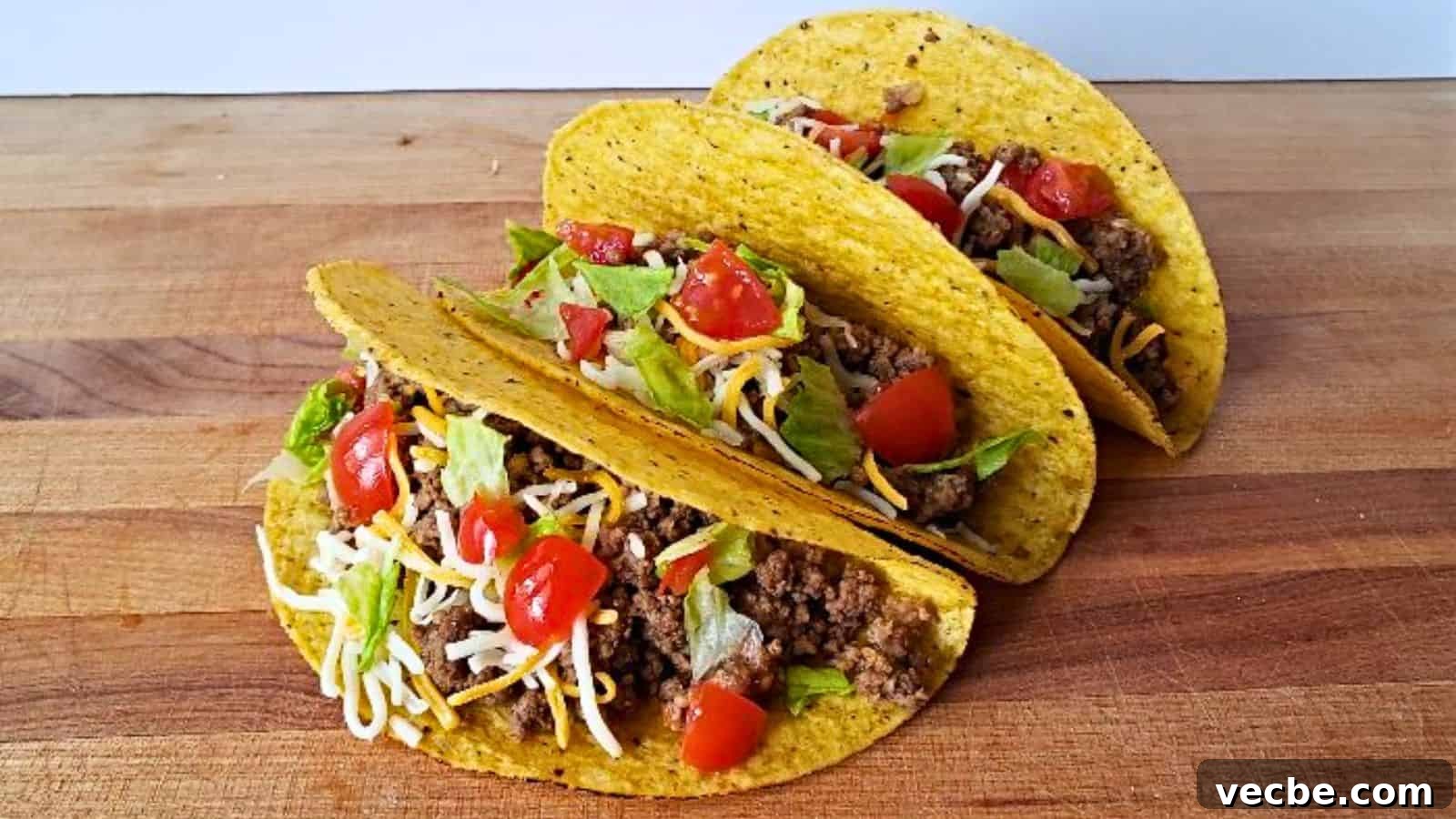19 Budget-Friendly Meals to Replace Takeout 4 Image shows three honey habanero tacos with corn shells sitting on a wooden board.