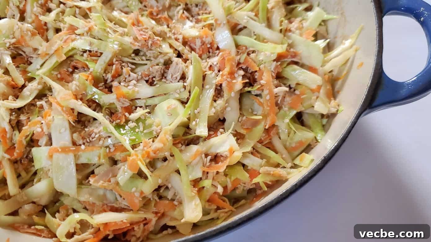 19 Budget-Friendly Meals to Replace Takeout 6 Image shows a closeup of chicken egg roll in a bowl in a blue enameled cast iron pot.