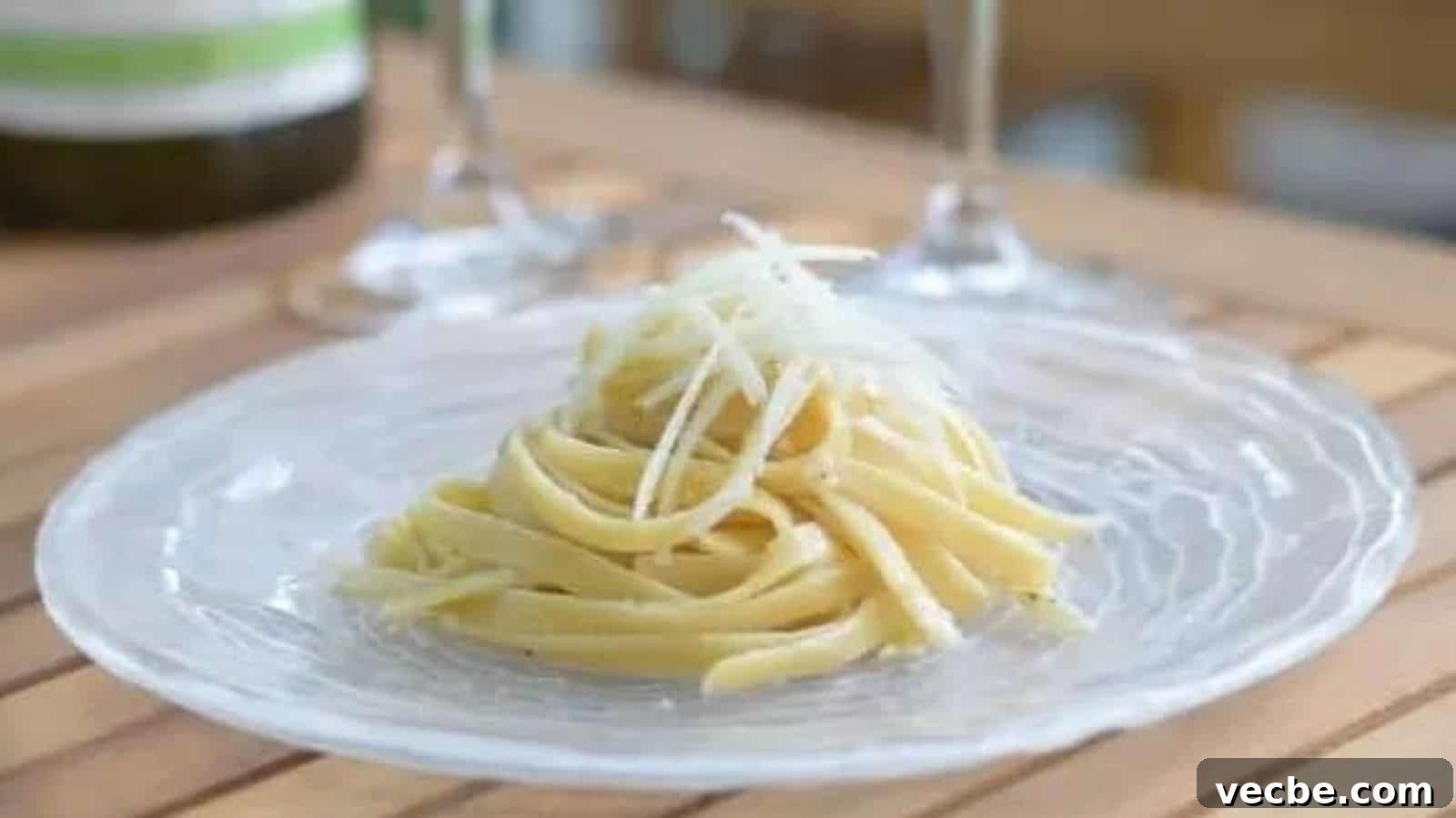 19 Budget-Friendly Meals to Replace Takeout 7 Image shows a plate with cacio e pepe in a neat pile topped with shaved parmesan cheese.
