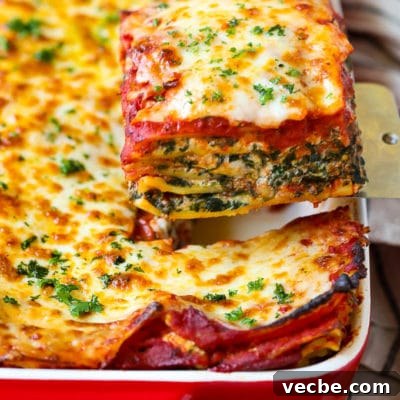 Spinach Lasagna with Ricotta and Mozzarella 2 A spatula serving up a slice of spinach lasagna.